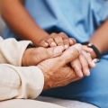 Nurse and patient holding hands
